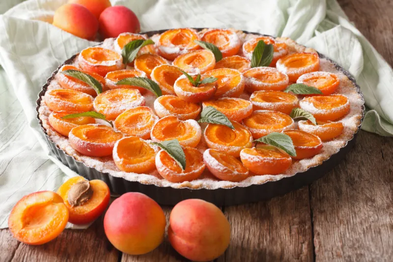 apricot tart with fresh mint close up in baking dish on the table horizontal