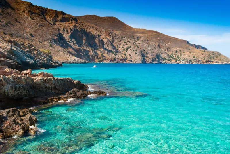 turquoise clear water of octopus bay and rocks, crete, greece in drapanos, greece
