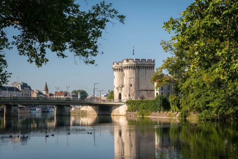 city gate and bridge over river meuse in verdun (france) on a sunny day in summer