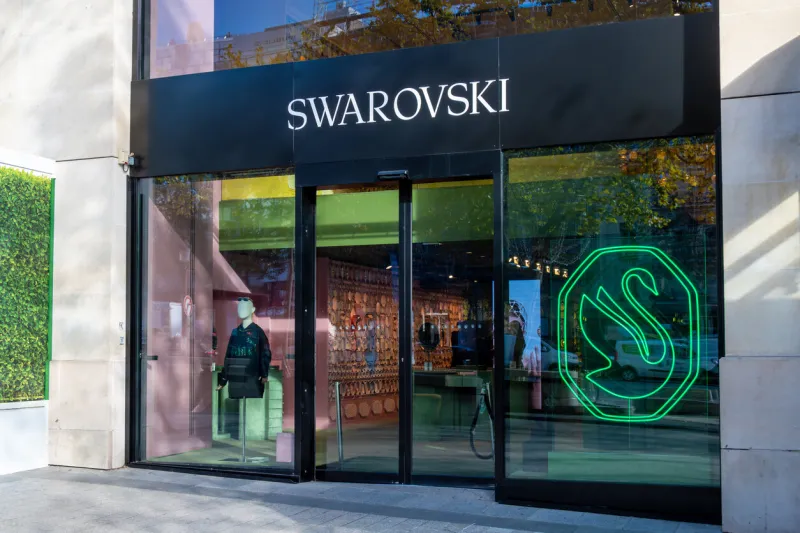 paris, france - november 6, 2023  exterior view of a swarovski boutique on avenue des champs-elysées swarovski is an austrian company manufacturing and marketing crystal glass jewelry and accessories