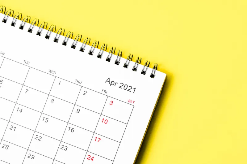 close up april 2021 calendar desk for organizer to plan and reminder on yellow table