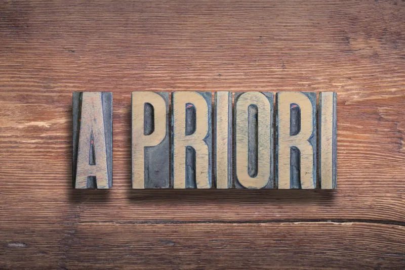 a priori ancient latin saying meaning «what comes before» combined on vintage varnished wooden surface