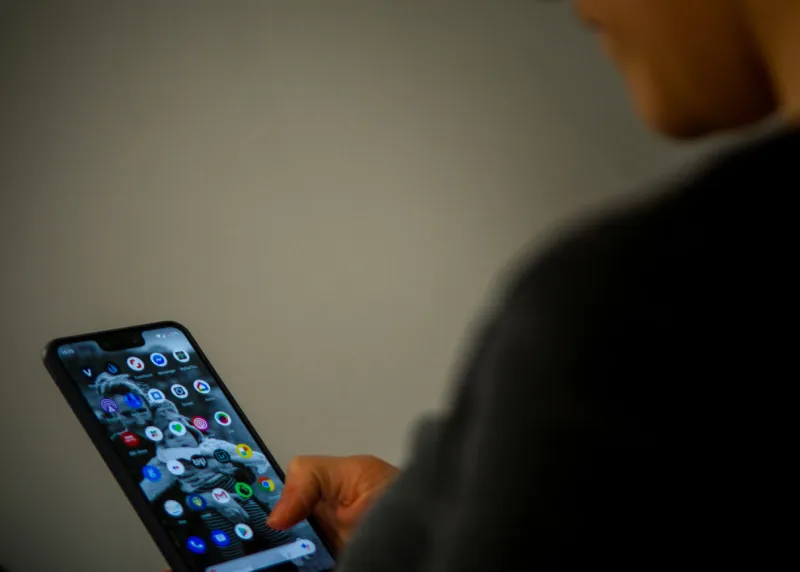 a close up shot of a person using the google pixel phone in a canid scene against a clean background