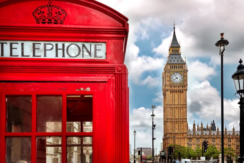london - big ben tower and a red phone booth