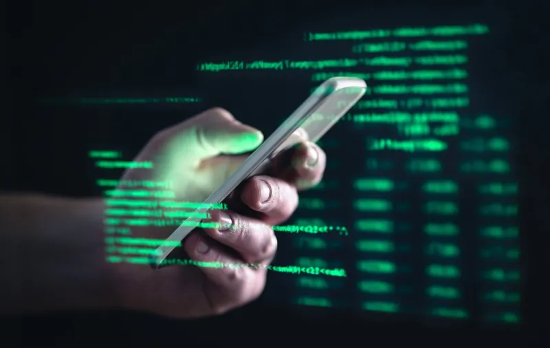 darkweb, darknet and hacking concept hacker with cellphone man using dark web with smartphone mobile phone fraud, online scam and cyber security threat scammer using stolen cell ar data code