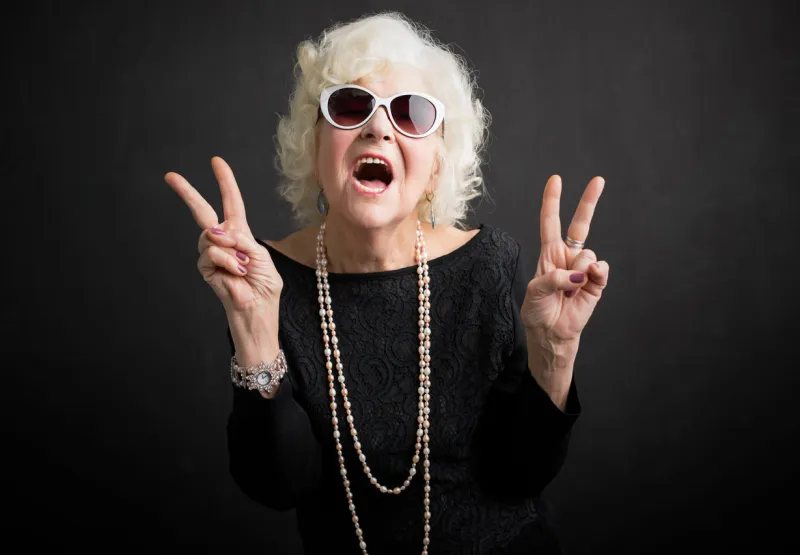 cool grandmother with sun glasses showing peace sign