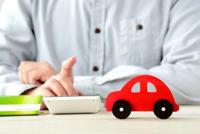 person thinking about cost for car