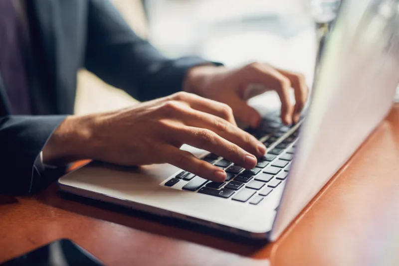 close up of a hands of a businessman on a keyboard