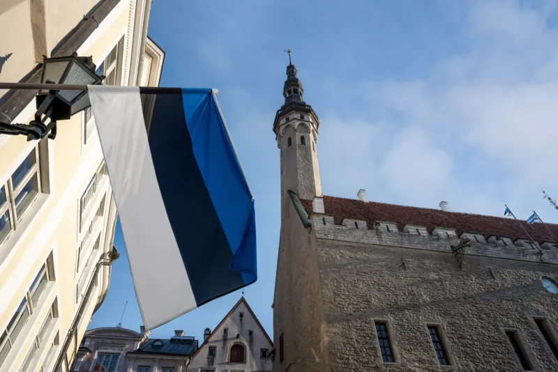 tallinn town hall and estonian flag - tallinn, estonia