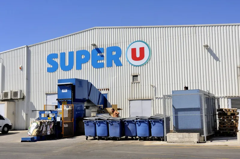 grau-du-roi, france - september 1, 2014  compaction of waste and packaging from a supermarket for recycling cardboard and other recyclable materials