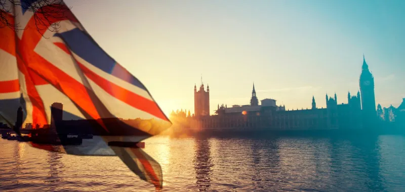 british union jack flag and big ben clock tower and parliament house at city of westminster in the background - uk votes to leave the eu, brexit concept