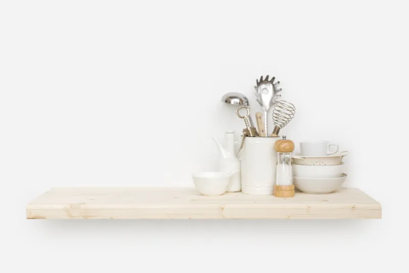various kitchen utensils on natural wooden shelf with copy space