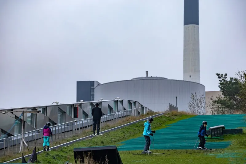 copenhagen, denmark nov 23, 2022 people skiing at the copenhill ski area, which doubles as a city icinerator and power plant
