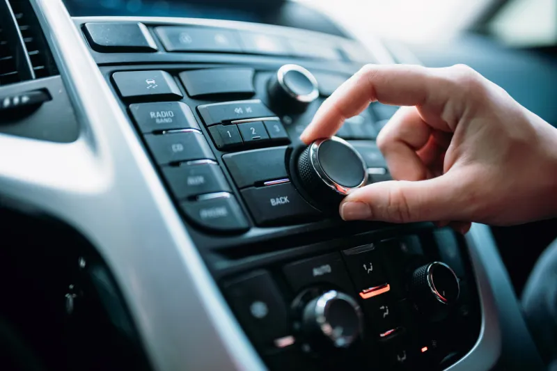 closeup of young woman hand control radio volume