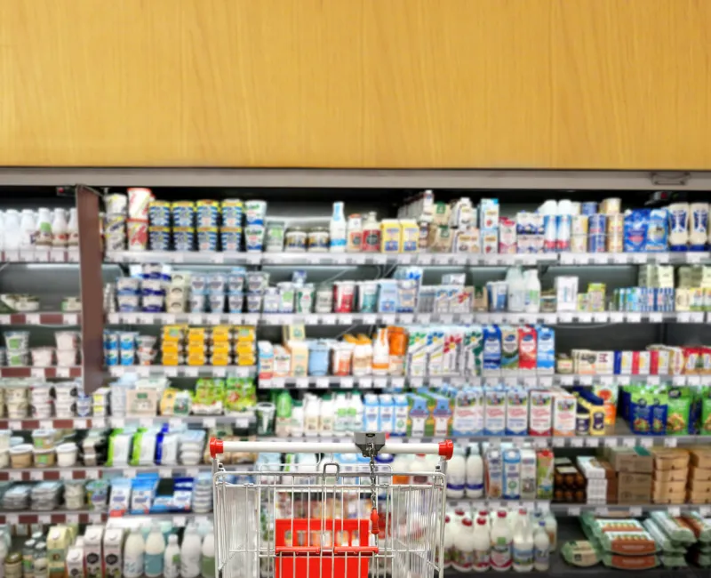 choosing a dairy products at supermarketempty grocery cart in an empty supermarket