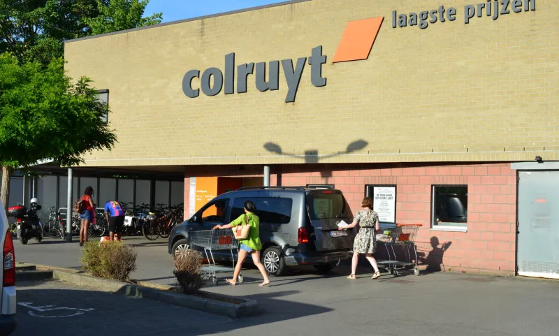leuven, vlaams-brabant, belgium - may, 14, 2022  exterior building colruyt leuven saturday sunset, belgian supermarket retailer ladies with shopping cart entering the shop