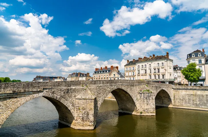 old stone bridge across the mayenne river in laval - pays de la loire, france