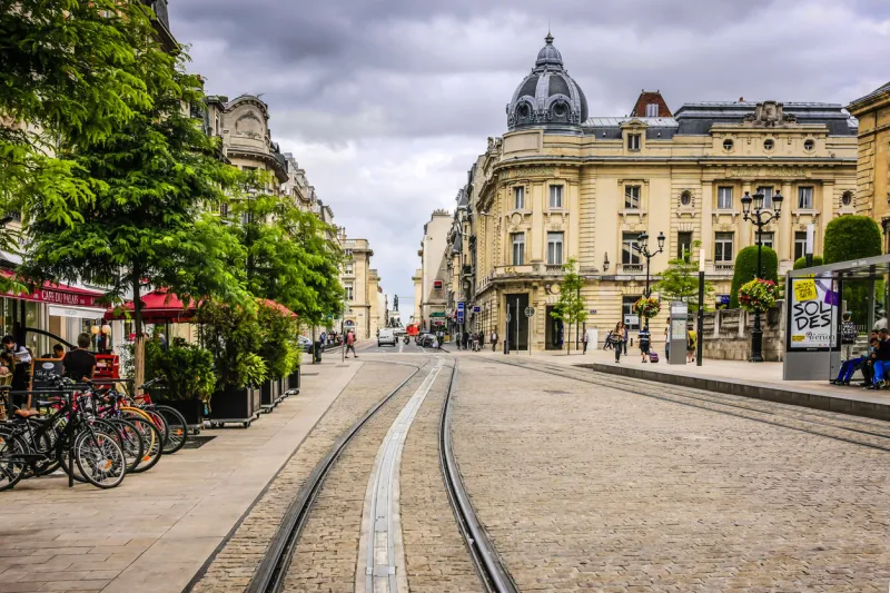 reims, france, eu - june 27, 2012  tram lines on the cobble-stoned rue des vesle in reims france after many false starts with a public transport system, the city as of 2011 has a mass transit system
