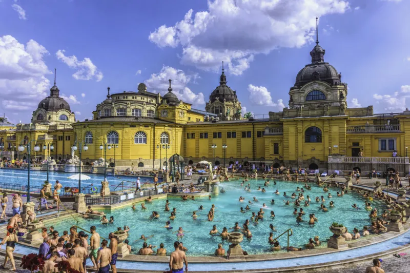 budapest, hungary - august 30, 2019  famous secheni thermal pools in budapest, hungary having fun and bathing people wellness complex of public therapeutic pools and saunas for water treatments budapest ancient tourist attraction