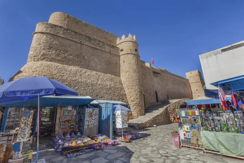 fortified castle with street shops in medina of hammamet, tunisia