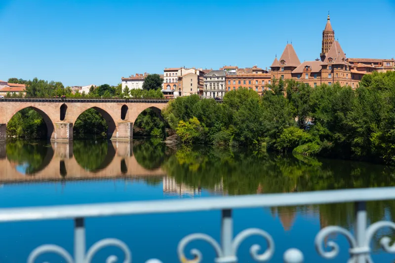 medieval bridge over the tarn river in montauban city on sunny day france
