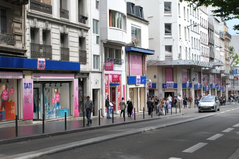 paris, france, june 21  residents and guests of the city stroll along a street near the shops of tati on june 21, 2012 in paris