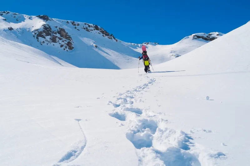 snowboarder alpinist on the alps mountains close to lac du lou, val thorens, france
