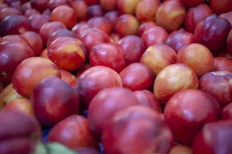 ripe nectarines background for sale at vegetable market