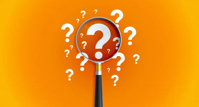 magnifier and question mark on orange background