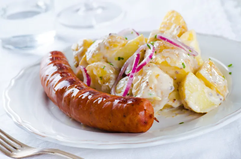 grilled sausage with classical potato salad with mayonnaise dres