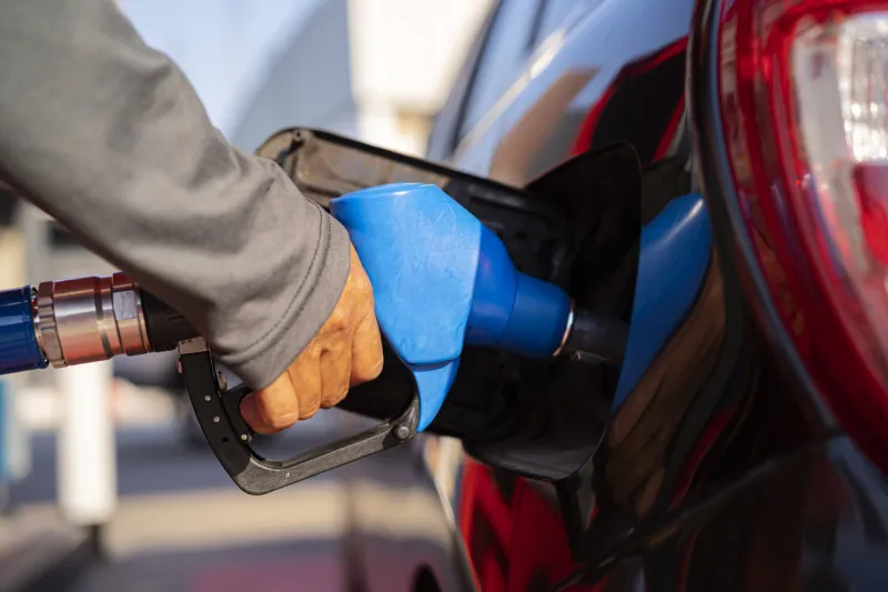 male worker holding fuel injector refueling car tank at gas station gas station for concept transportation energy business technology concept