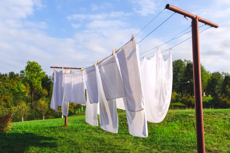 fresh clean white sheet drying on washing line in outdoor