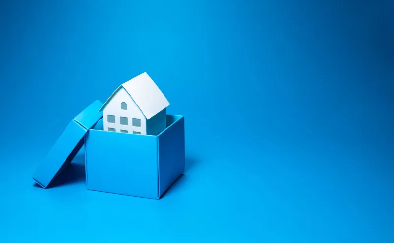 business property and real estate concepts with white model house inside small box over all on pastel color background