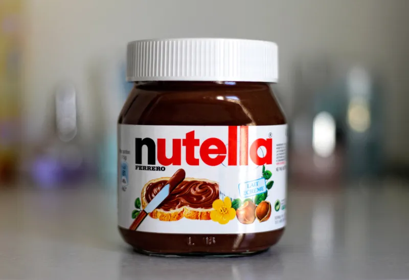 paris, france - february 22, 2012  jar of nutella hazelnut on a bokeh background nutella is the brand name of a chocolate hazelnut flavored sweet spread by the italian company ferrero