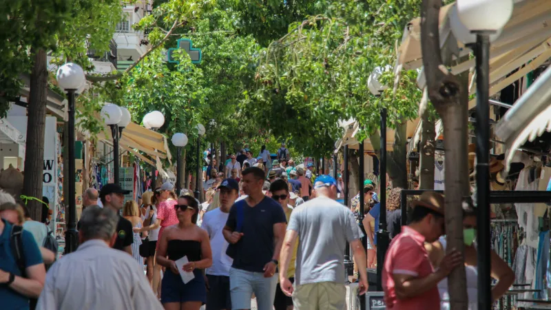 heraklion, greece – march 08, 2022  a busy old road packed with people and shops in heraklion, crete, greece