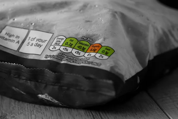 food nutrition label on the front of a bag of frozen sliced carrots