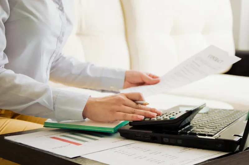 finance girl working online girl looks at the document sign contract high quality photo