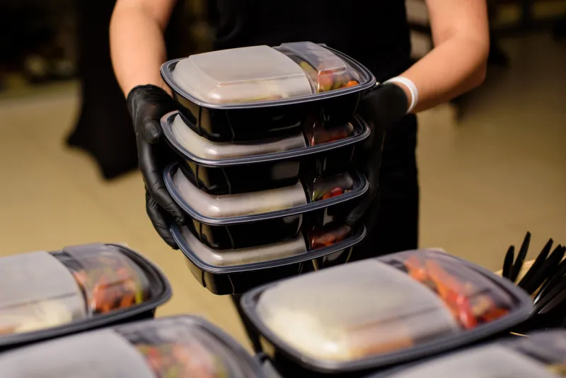 lunch box with food in the hands catering