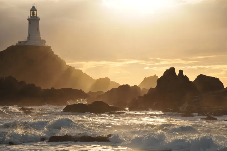 telephoto image of lighthouse reef with winter stormy weather