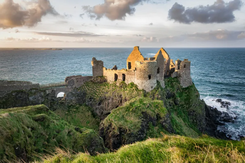 this is a picture of the ruins of dunluce castle in northern ireland it was built in the 13th century on the top of a sea cliff looking out to the atlantic ocean