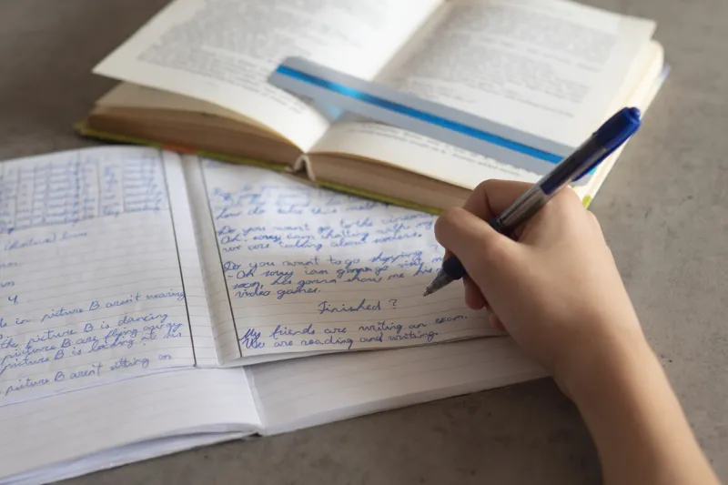 kid affected by dyslexia doing homework, reading book using colorful overlay strip education, learning disability, reading difficulties concept