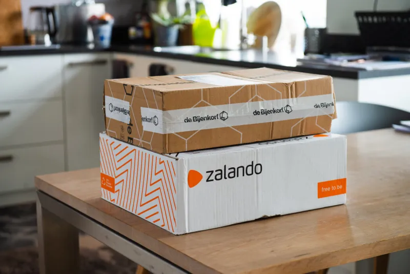 amsterdam, the netherlands, 12-29-2020 zalando and de bijenkorf online package delivery, unboxing package, online shopping, fashion, box on the table, return to sender