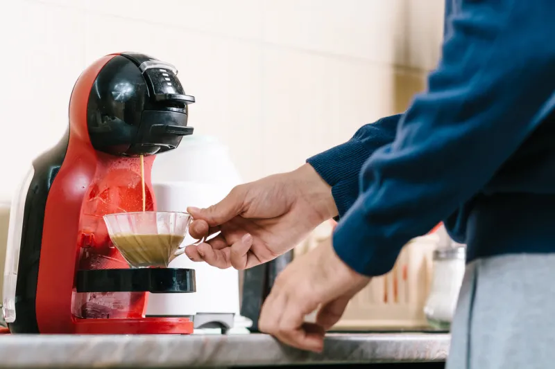 man making coffee with coffee maker