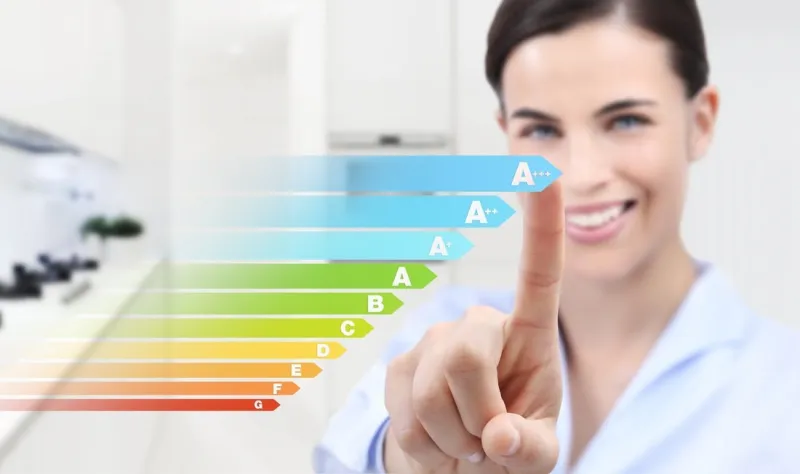 energy efficiency smiling woman hand touch screen with colored symbols on interior room background web banner and copy space template