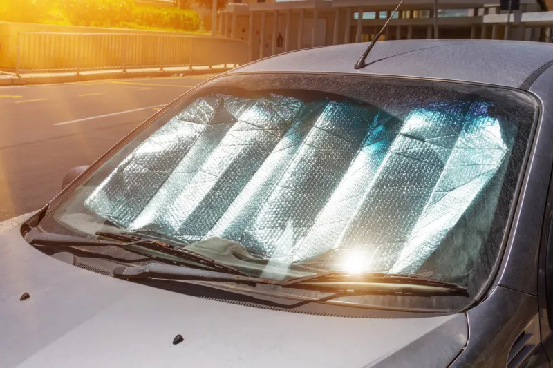protective reflective surface under the windshield of the passenger car parked on a hot day, heated by the sun's rays inside the car