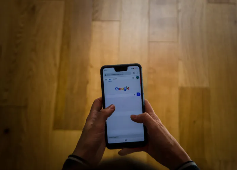 a close up shot of a person using the google pixel phone in a canid scene against a clean background