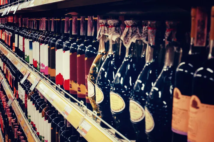 showcase in a wine shop with bottles of wine and champagne