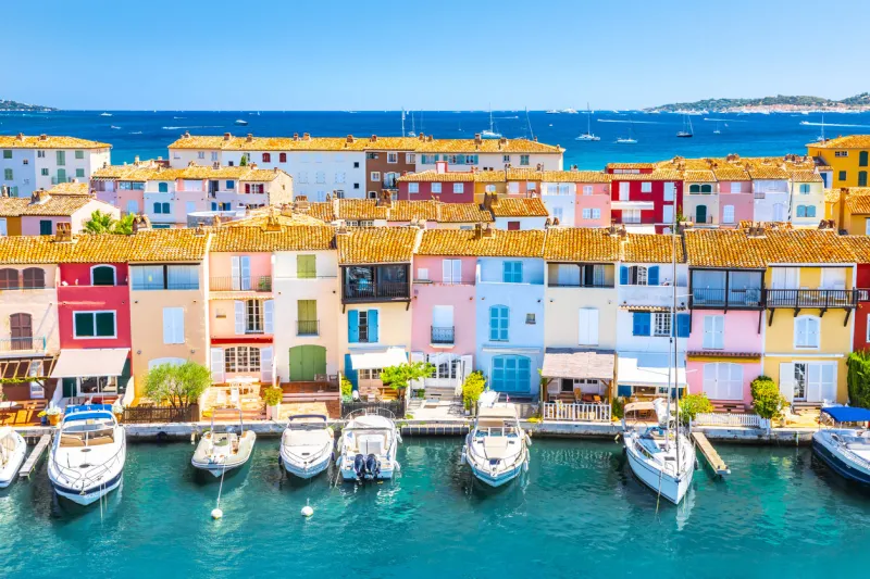view of colorful houses and boats in port grimaud during summer day-port grimaud, france
