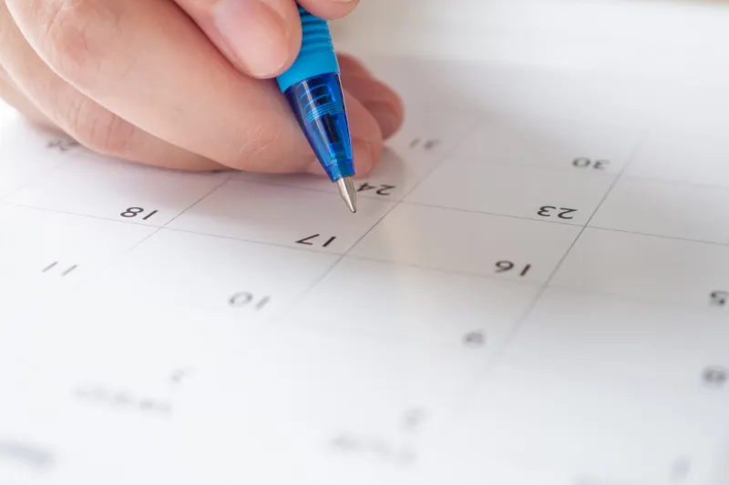 woman hand with pen writing on calendar date business planning appointment meeting concept