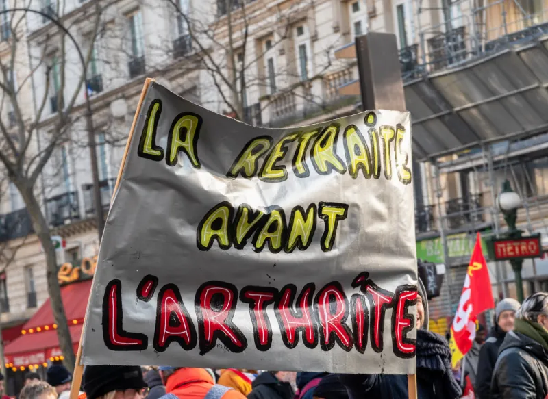 paris, france - january 24 2020   protest against the retirement pension reform of president macron - banner with the slogan retirement before arthritis